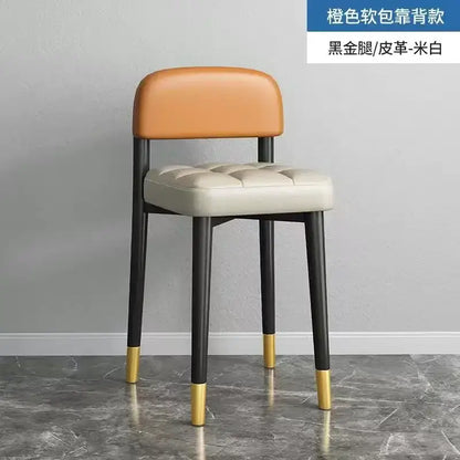 Decorbites low square stool bench with orange and off-white leather and gold-accented black legs for dining and kitchen use