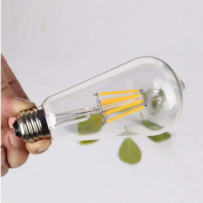 Clear glass decorbites low voltage led bulb with glowing yellow filaments and metallic screw base for retro cabin use