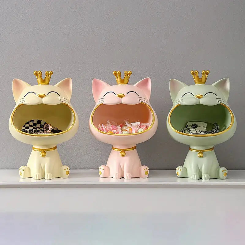 Three ceramic lucky cat sculpture storage boxes in cream pink and mint green with golden crowns and collars