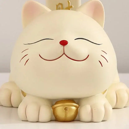 Cream-colored resin decorbites lucky cat statue with red nose closed eyes and golden bell for home decor and storage