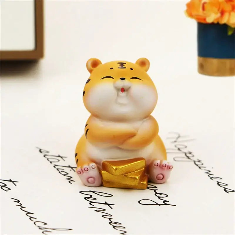 Cute yellow and white lucky tiger figurine with black stripes pink paws and gold coin for new year fortune decor
