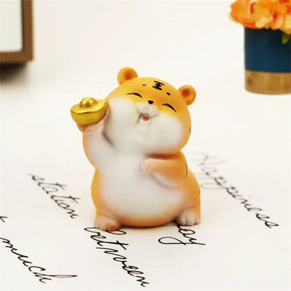 Cute orange and white ceramic lucky tiger figurine holding a golden ingot for new year fortune home decor