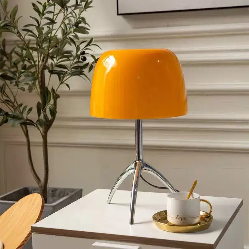 Vibrant orange glossy ceramic decorbites lumiere glass table lamp with sleek chrome tripod base for bedroom and living room