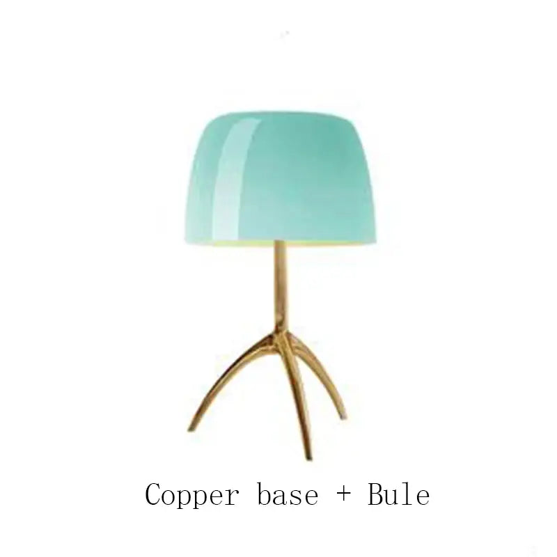 A table lamp with a glossy teal glass shade and polished copper tripod base decorbites lumiere piccola chrome