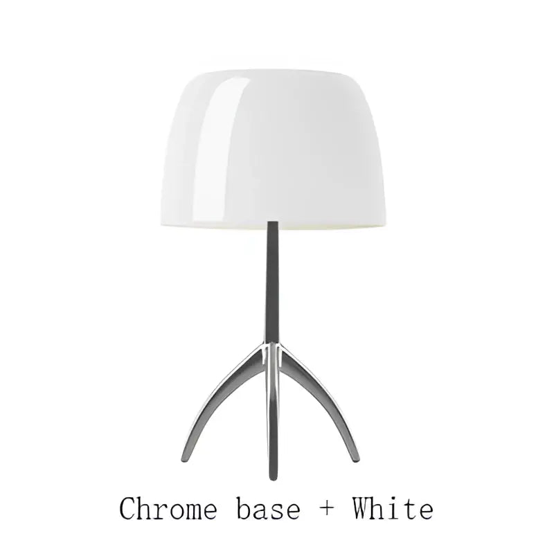 A sleek white table lamp with a glossy dome shade and chrome tripod base from decorbites lumiere piccola chrome