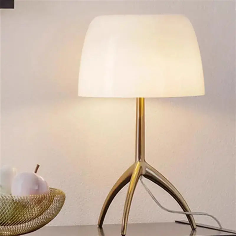 Gold-toned decorbites lumiere piccola chrome table lamp with soft off-white opal glass shade for bedside use