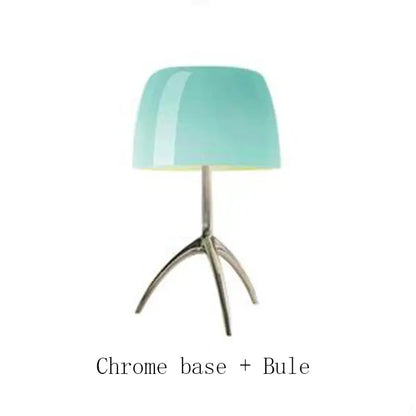 A decorbites lumiere piccola chrome table lamp with a glossy teal glass shade and polished chrome tripod base for bedside use
