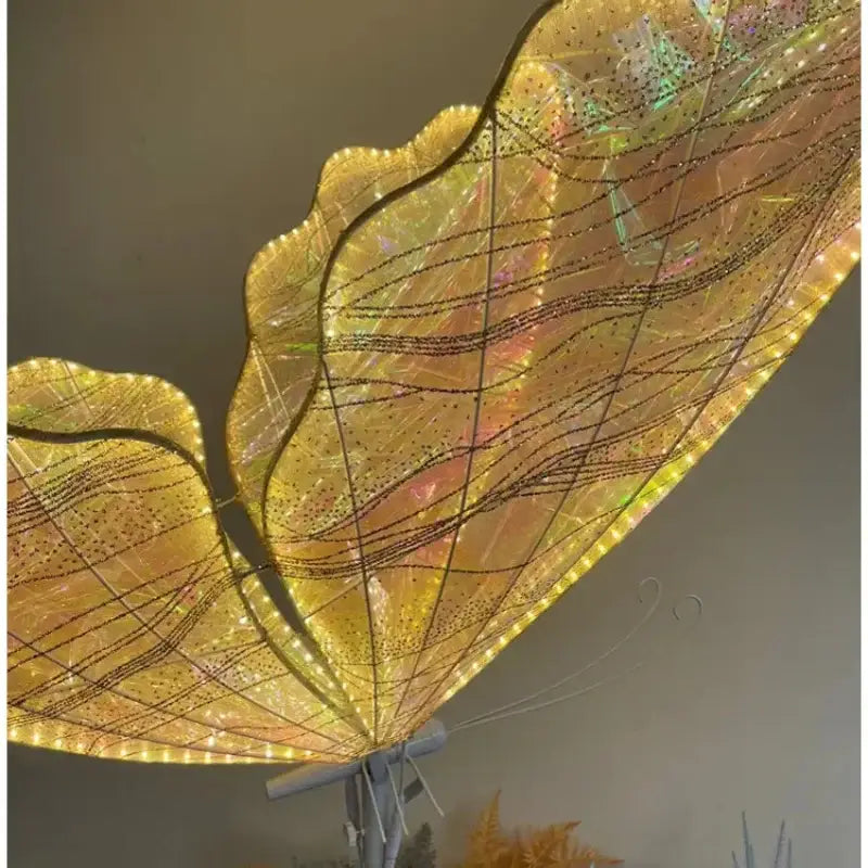 Glowing golden decorbites luminescent butterfly floor lamp with intricate wireframe and embedded led lights for weddings