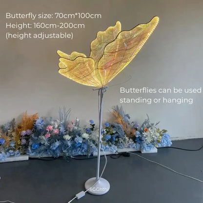 Golden butterfly-shaped floor lamp with illuminated wings and slender metallic stand by DecorBites luminescent butterfly LED