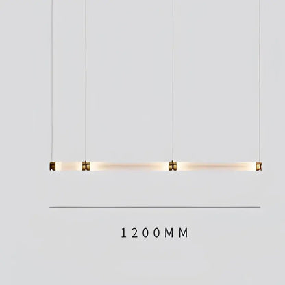 A sleek luna glass tube chandelier with four cylindrical glass tubes suspended by cables for kitchen or dining lighting