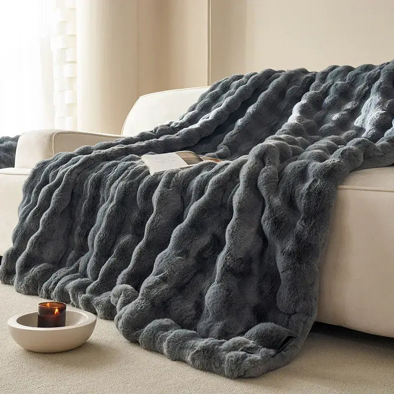 A plush dark gray decorbites luxe faux rabbit fur throw blanket with chunky knit pattern for cozy sofa cover