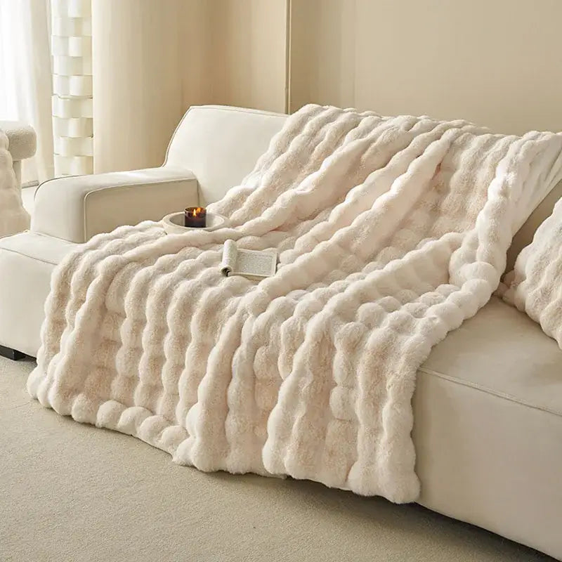 Cream-colored decorbites luxe faux rabbit fur blanket with plush chunky knit texture for cozy autumn winter sofa cover