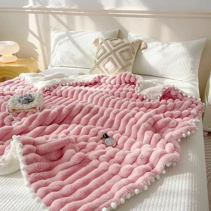 Pink fluffy weighted blanket with pom-poms and floral pattern made from luxe faux rabbit wool for cozy warmth