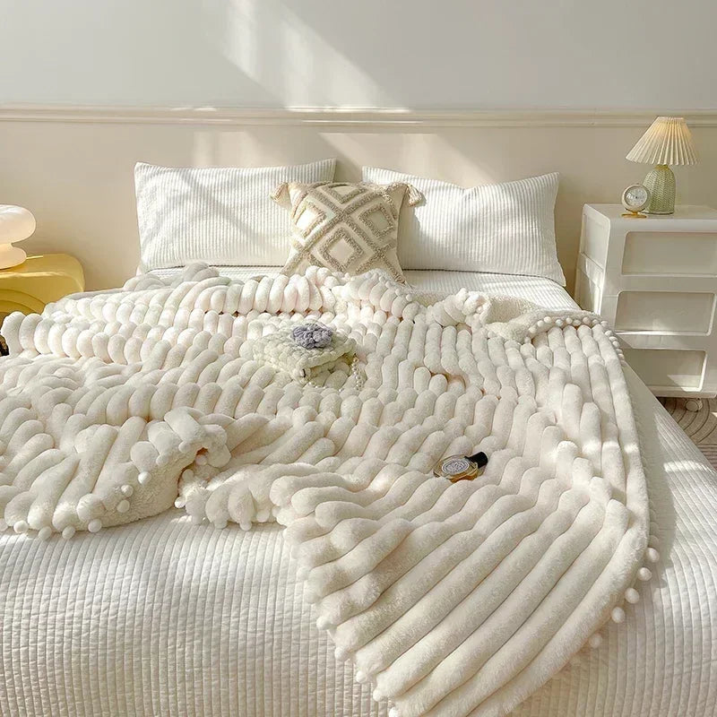 Cream-colored chunky knit weighted blanket with pom-poms made from luxe faux rabbit and lambs wool for cozy warmth