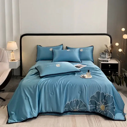 Blue satin quilt set with embroidered floral designs and black lace trim from decorbites luxe flower collection