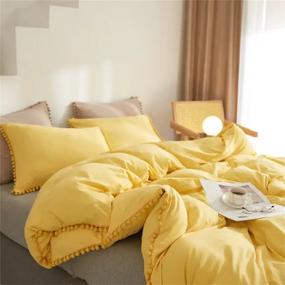 Yellow pom-pom trim bedding set from decorbites luxe furball tasseled collection queen king size duvet cover