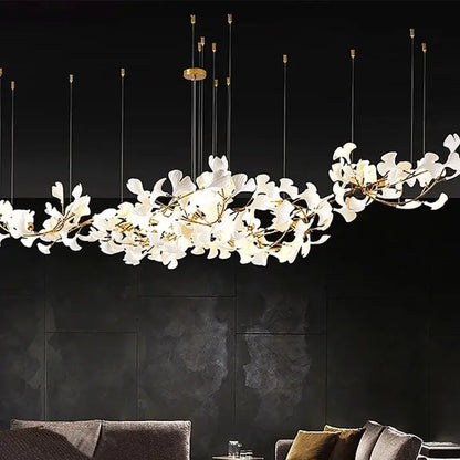 Elegant white porcelain pendant light with gold-toned branches and slender rods decorbites luxe ginkgo leaves chandelier
