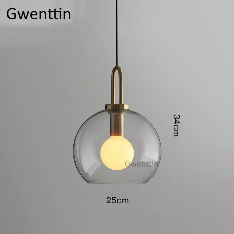Decorbites luxe glass ball pendant light with clear glass globe brass accents and warm glowing bulb for home decor