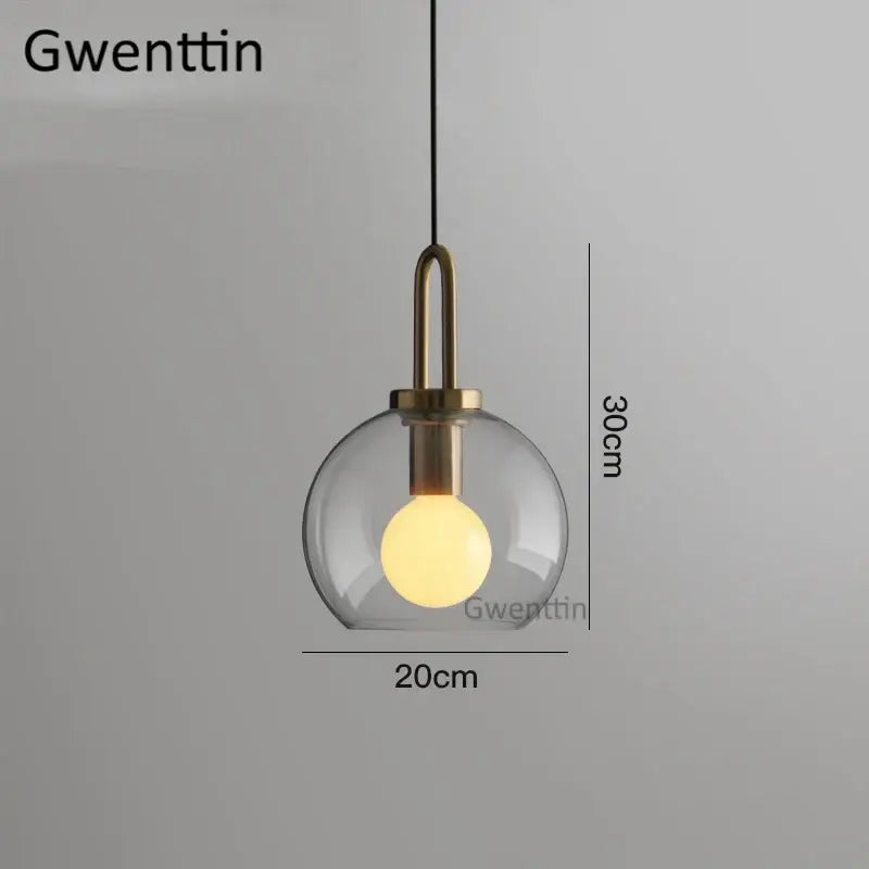 A decorbites luxe glass ball pendant light with clear glass globe brass fixture and hanging cord for home decor