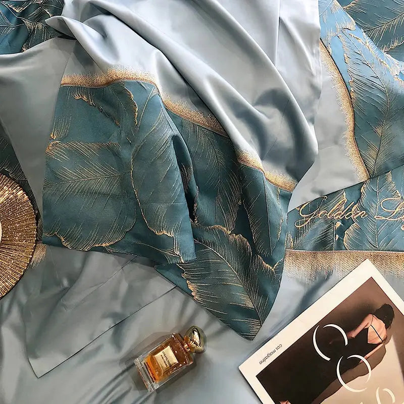 Teal satin bedsheet with gold leaf satin jacquard embroidery and golden script from decorbites 1000tc egyptian cotton bedding set