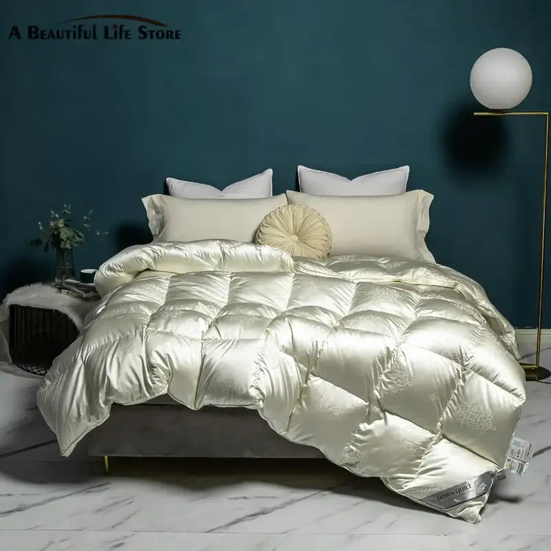 Cream-colored satin quilt with subtle embroidery and plush texture in decorbites luxe goose duck down quilt queen king size