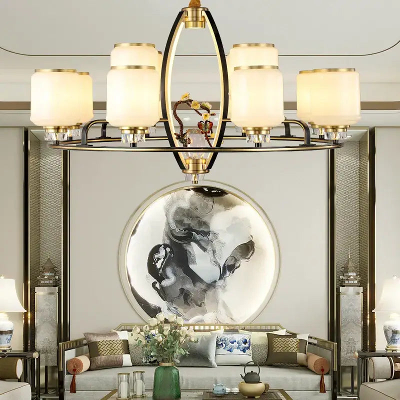 Gold-toned decorbites luxe jade chandelier with six frosted glass shades and central decorative element for living rooms