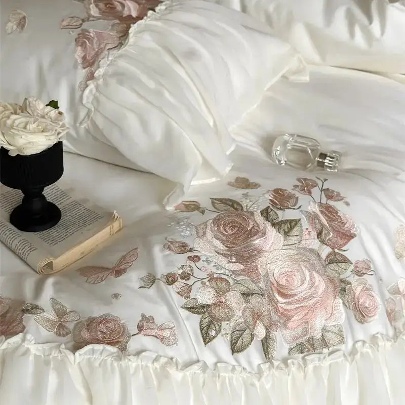 White satin bedding set with delicate pink and beige floral embroidery and ruffled edge from decorbites luxe lace ruffles collection