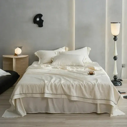 Cream-colored decorbites luxe lyocell summer blanket with mulberry silk fill comforter featuring black piping edges