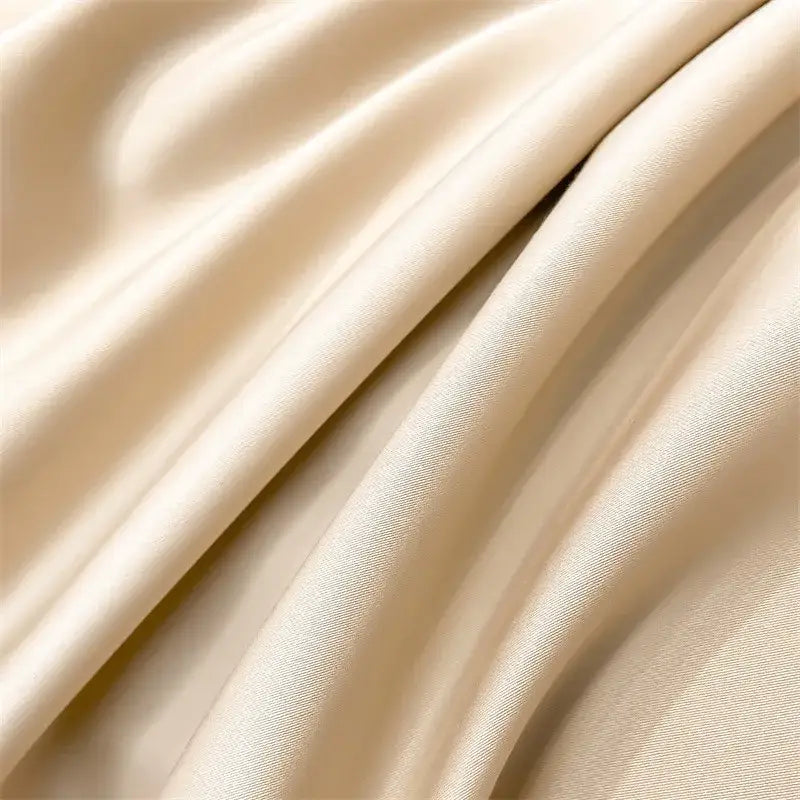 Cream-colored satin duvet cover from DecorBites™ 1000TC Egyptian cotton bedding set with smooth glossy finish and gentle folds