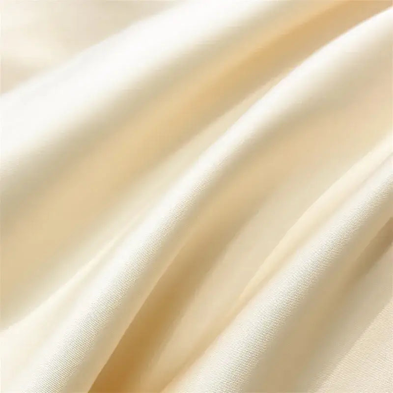Cream-colored satin finish on DecorBites™ luxurious 1000TC Egyptian cotton fitted sheet and duvet cover fabric