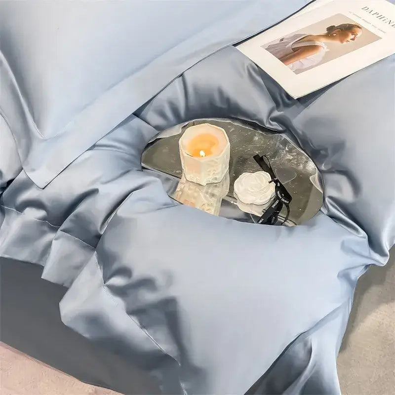 A small mirrored tray holding a lit candle and black glasses near DecorBites luxurious 1000TC Egyptian cotton duvet cover