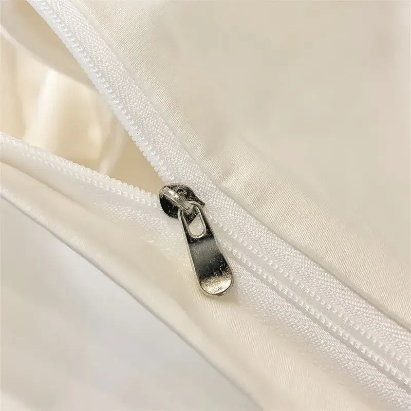 Silver zipper pull on white fabric seam of decorbites luxurious 1000tc egyptian cotton duvet cover or fitted sheet