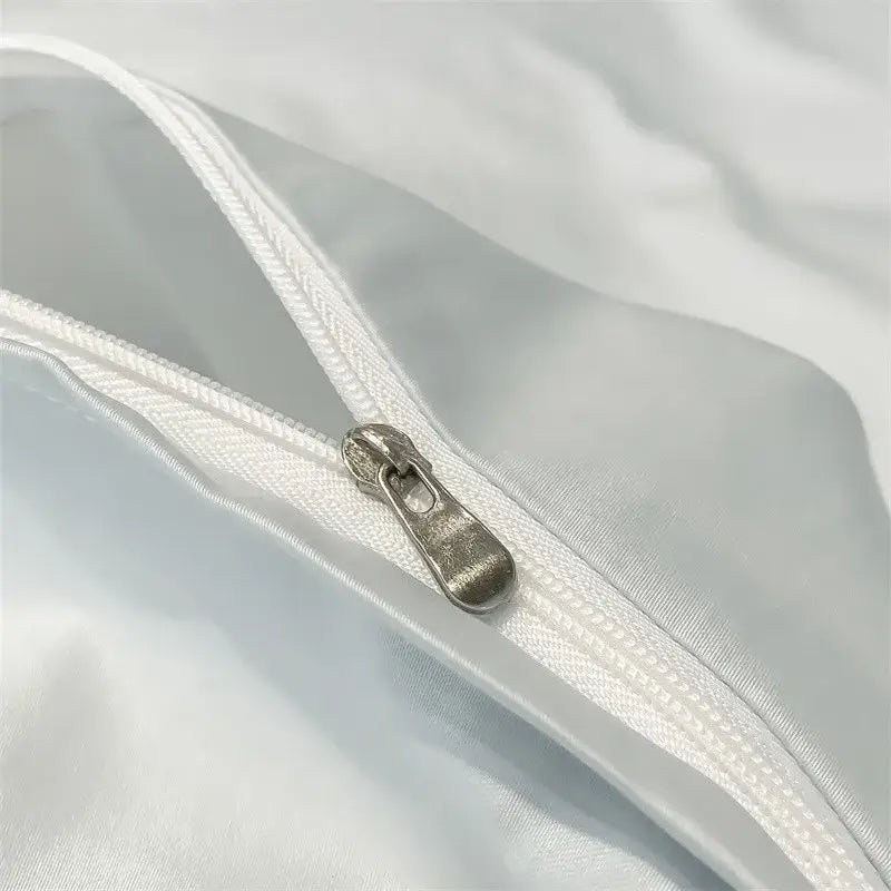 Silver-toned zipper pull on white satin-like fabric of decorbites™ luxurious 1000tc egyptian cotton duvet cover