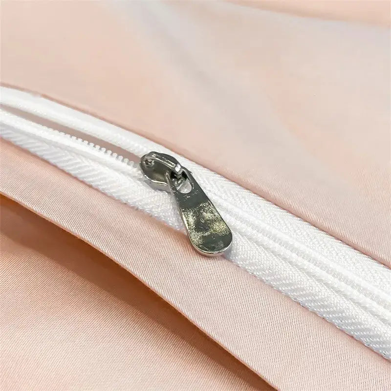 A silver-toned zipper pull with a matte finish on a white zipper track of decorbites luxurious 1000tc egyptian cotton duvet cover