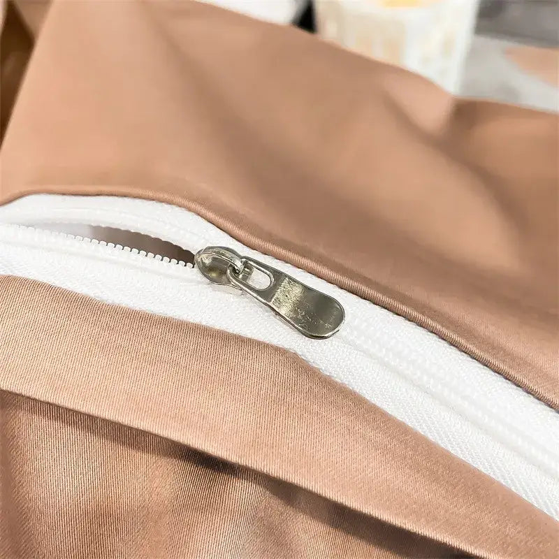 A sleek metallic zipper on the taupe fitted sheet of the decorbites™ luxurious 1000tc egyptian cotton bedding set