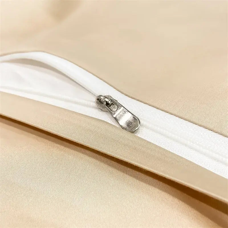A sleek silver zipper on a beige satin pillowcase of the DecorBites™ luxurious 1000TC egyptian cotton duvet cover set