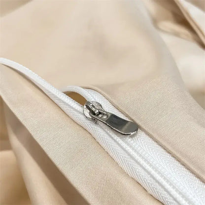 A sleek silver zipper with a metallic pull tab on a beige egyptian cotton duvet cover from decorbites 1000TC set