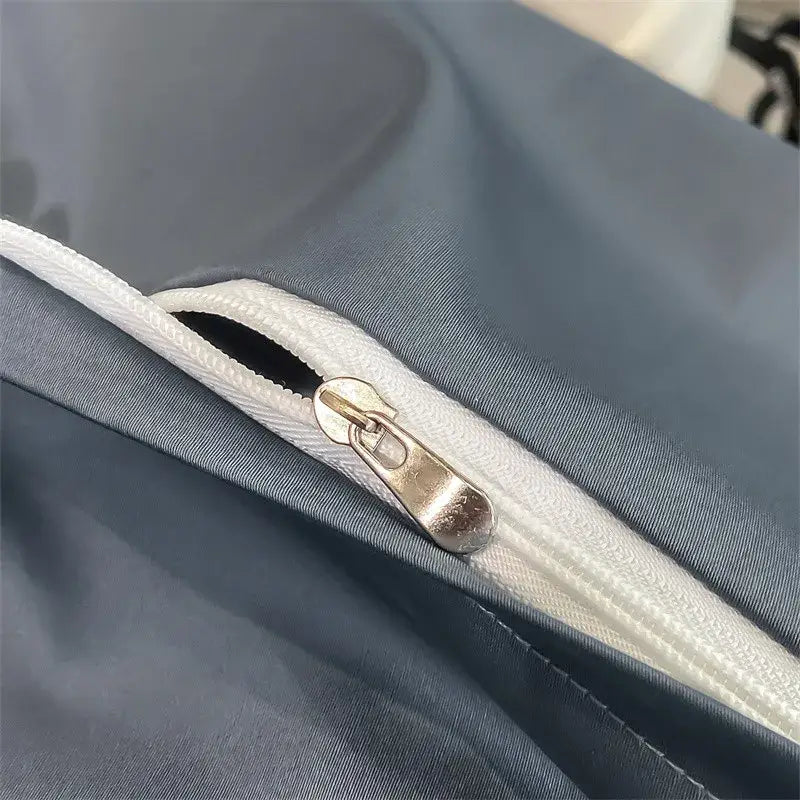A sleek silver zipper with metallic pull tab on dark gray decorbites™ luxurious 1000tc egyptian cotton duvet cover