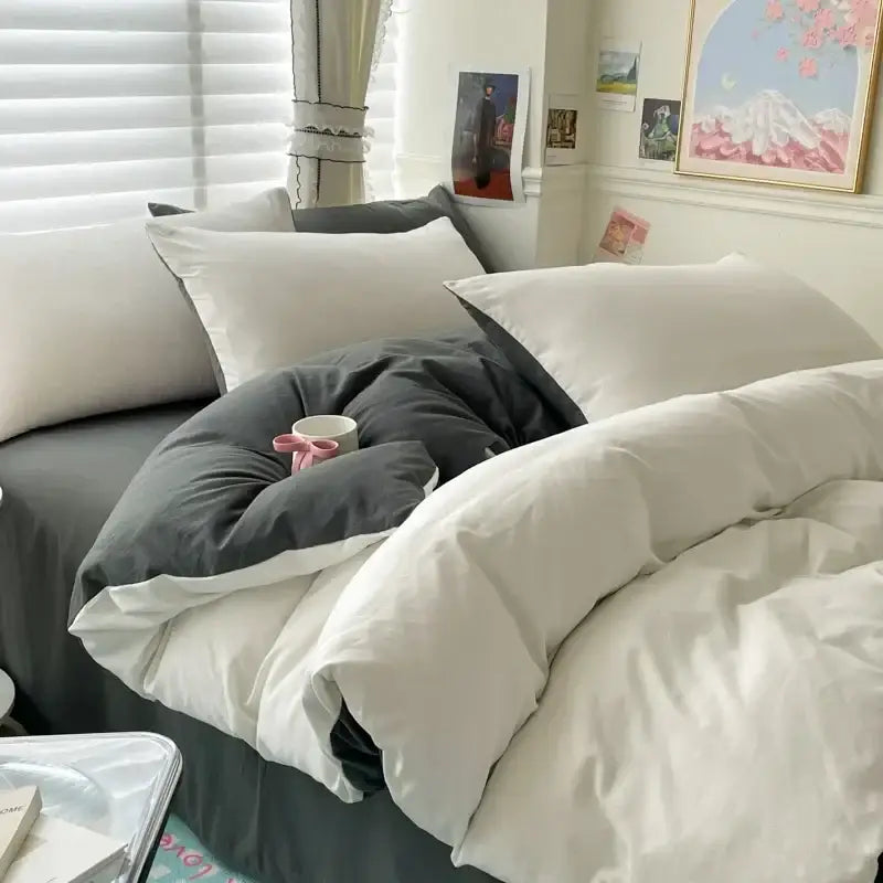A cozy decorbites luxurious cotton bedding set with soft white and dark gray duvet cover and matching pillows