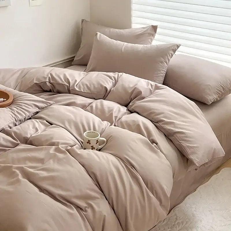 Beige quilted cotton bedding set with duvet cover and matching pillows featuring soft fabric finish and subtle stitching details