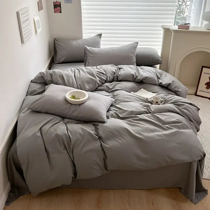 Gray cotton bedding set with duvet cover and matching pillows featuring a soft slightly wrinkled texture by decorbites
