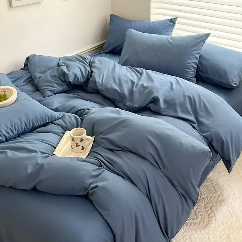 Soft dusty blue quilted cotton bedding set featuring duvet cover and matching pillows from decorbites luxurious line