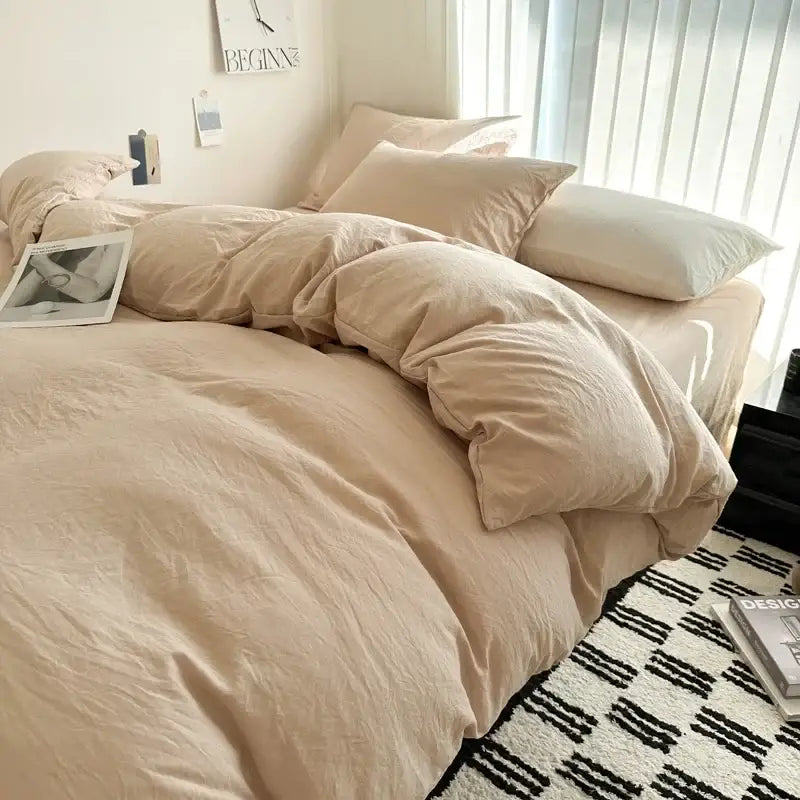 Beige cotton bedding set with duvet cover and matching pillows softly rumpled for a cozy bedroom by DecorBites