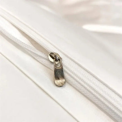 Silver-toned zipper pull on white fabric zippered seam of decorbites luxurious egyptian cotton duvet cover 1000tc