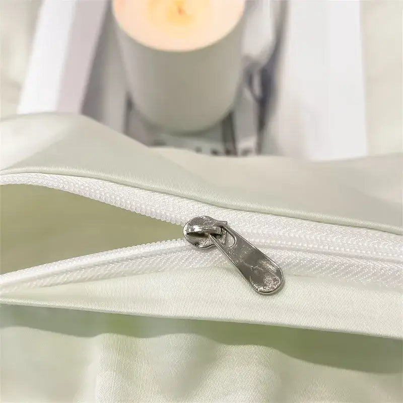 A sleek silver zipper on pale green satin fabric of decorbites™ luxurious egyptian cotton duvet cover 1000tc ultra soft