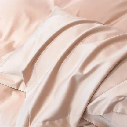A soft blush pink satin pillowcase from DecorBites™ luxurious Egyptian cotton bedding set with duvet cover and fitted sheet