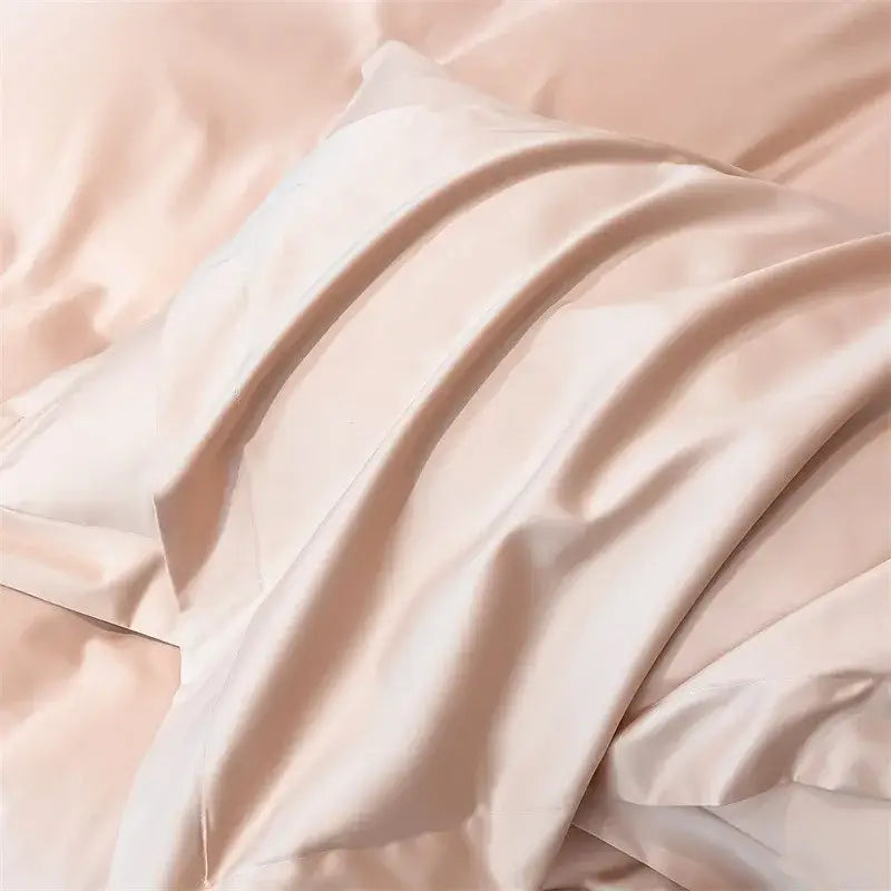 A soft blush pink satin pillowcase from DecorBites™ luxurious Egyptian cotton bedding set with duvet cover and fitted sheet
