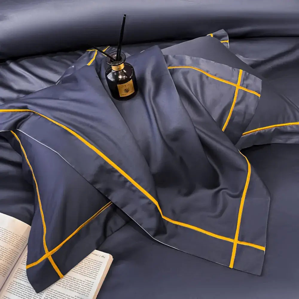 Dark blue satin pillowcase with bold yellow geometric stitching from DecorBites™ luxurious Egyptian cotton bedding set