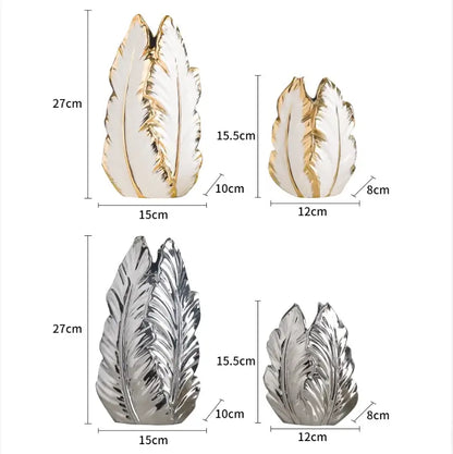 Set of four decorative leaf-shaped luxurious gold ceramic vases in white and metallic finishes for home decor