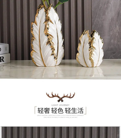 White ceramic gold ceramic vases with gold leaf detailing shaped like stylized feathers for home decor